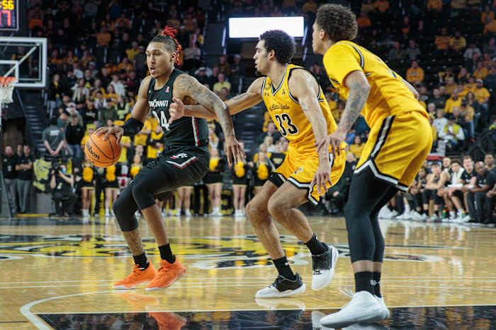 Jan 5, 2023; Wichita, Kansas, USA; Cincinnati Bearcats guard Jeremiah Davenport (24) works around Wichita State Shockers forward James Rojas (33) during the second half at Charles Koch Arena. Mandatory Credit: William Purnell-USA TODAY Sports